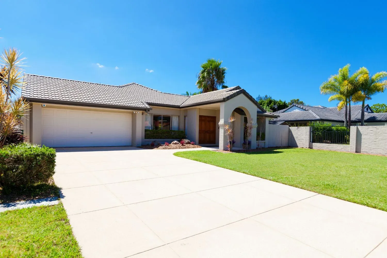Finished concrete driveway leading to a Melbourne home