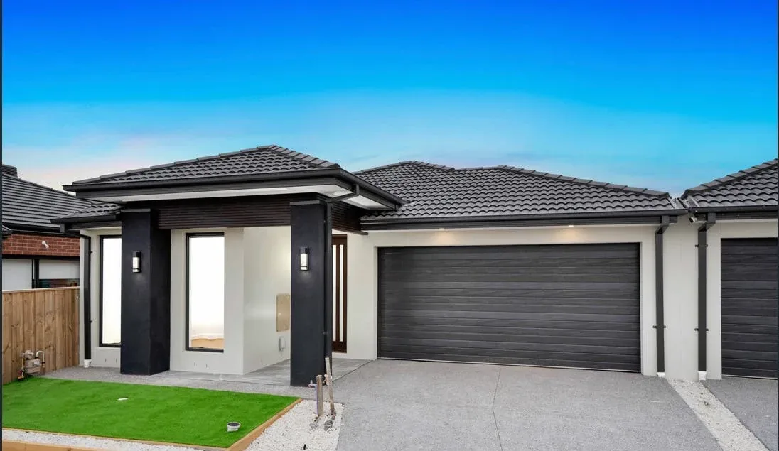Grey home with concrete driveway